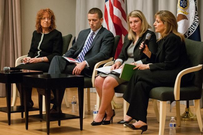 Panelists, including GLIFAA President Robyn McCutcheon, T.J. Mahoney from Marriott, and Tricia Reville from GE, listen as Rosie Allan from Booz Allen Hamilton describes her company’s approach.